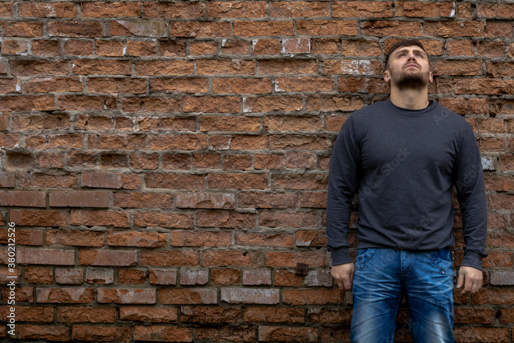 Man on the background of a red brick wall. Man on the background of a red brick wall.