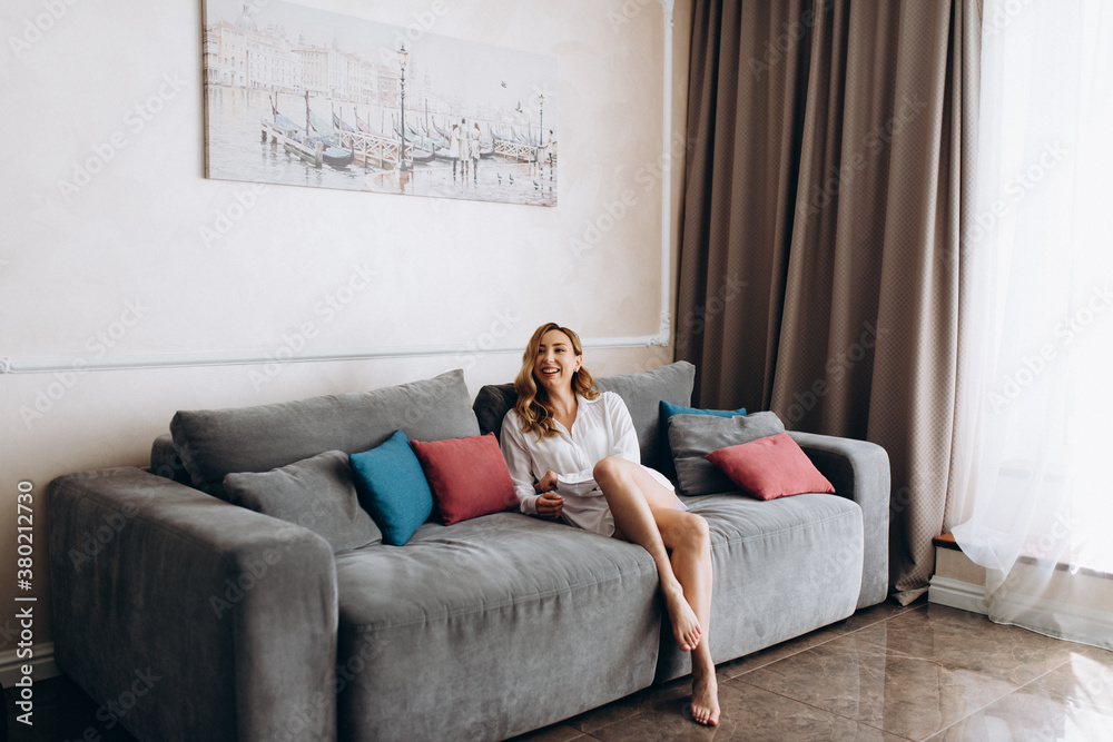 Obraz premium Calm millennial woman relaxing on soft comfortable sofa meditating or having daytime nap, carefree lazy girl breathing fresh air enjoying no stress free peaceful weekend morning resting on couch