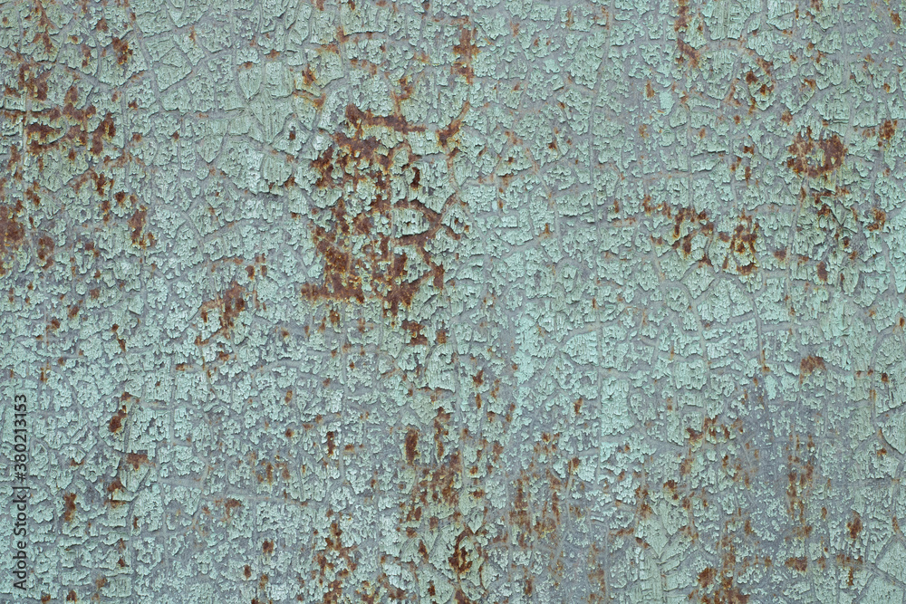 The wall is made of old rusty metal.