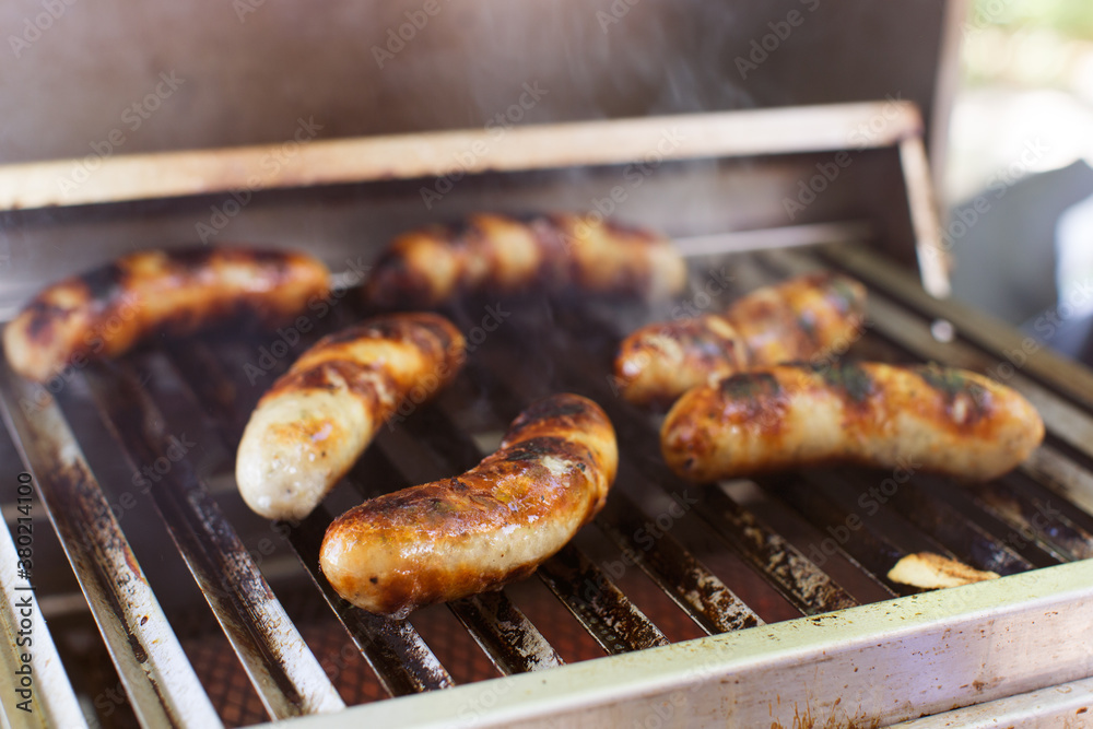Sausages being cooked on an open grill Sausages being cooked on an open grill