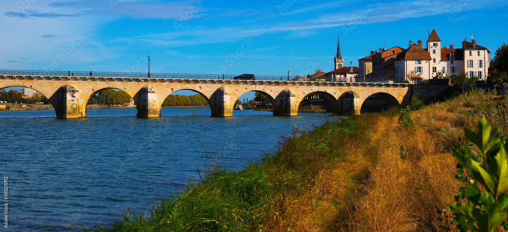 Old arch Saint-Laurent bridge over river in Macon, France