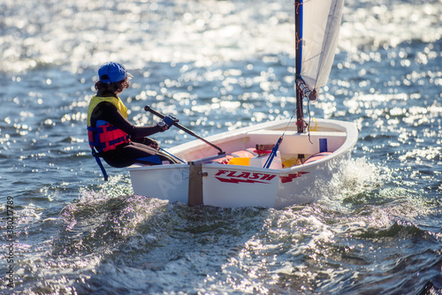 Boy sailing an optimist dinghy photo