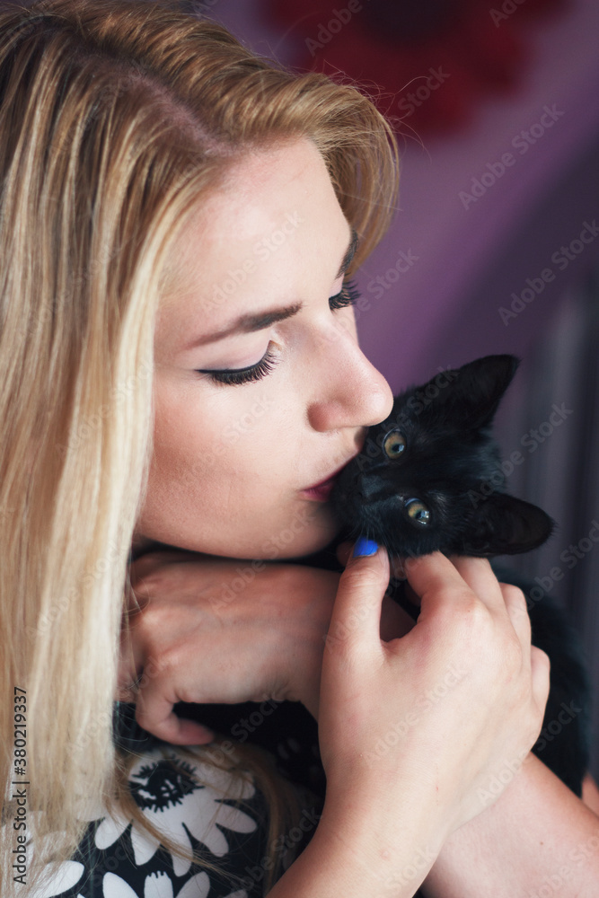 Young beautiful woman kissing little kitten Young beautiful woman kissing little kitten