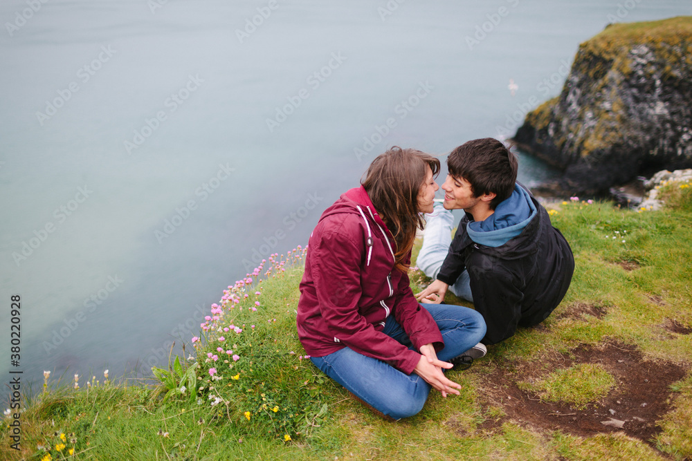 Young Couple Kissing in the Edge of the Cliff Young Couple Kissing in the Edge of the Cliff