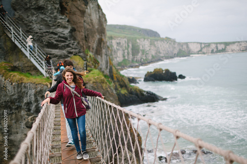 Young Couple Crossing Rope Bridge in Northern Ireland photo