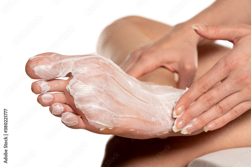 Woman applying foot mask on her sole feet Woman applying foot mask on her sole feet