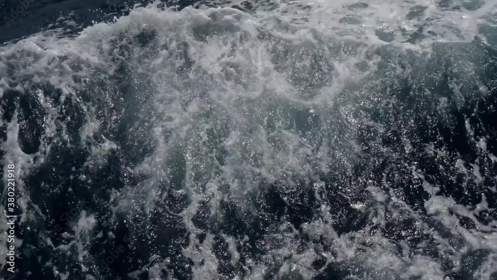 large ship quickly sails on the open sea during the day in summer creates waves large ship quickly sails on the open sea during the day in summer creates waves