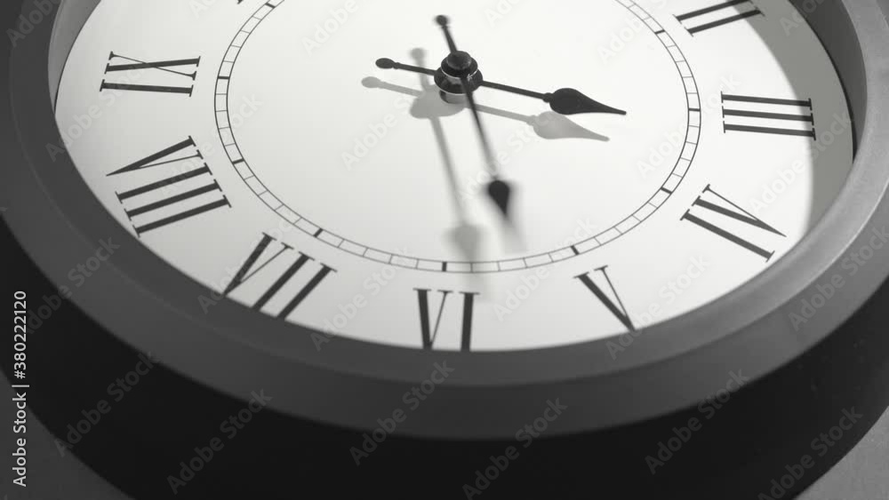 Latin Clock Face in Time Lapse on Dark Grey Wall Latin Clock Face in Time Lapse on Dark Grey Wall