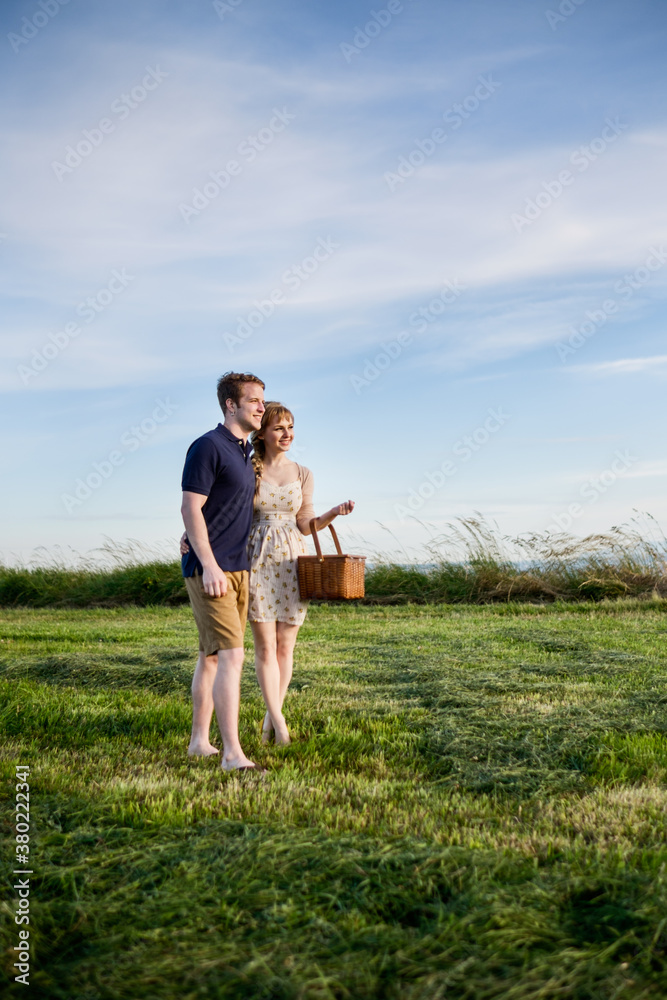 Young couple having picnic together in a park Young couple having picnic together in a park