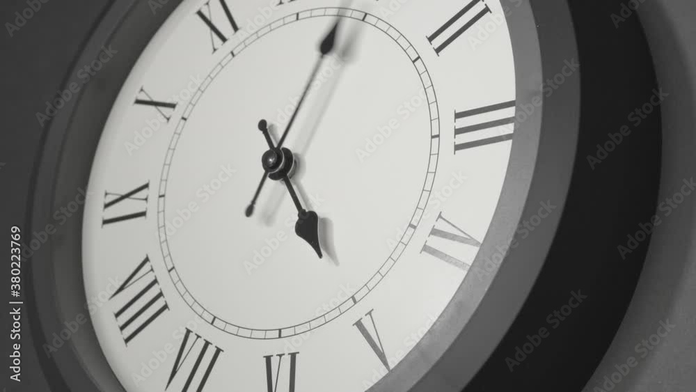 Latin Clock Face in Time Lapse on Dark Grey Wall Latin Clock Face in Time Lapse on Dark Grey Wall