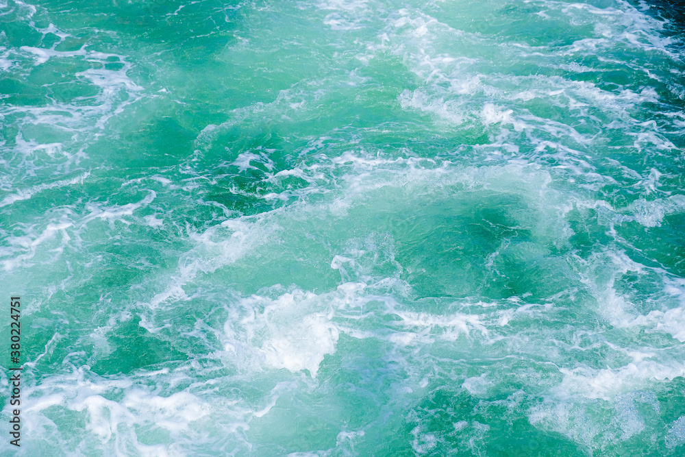 thundering ocean waves  or waves on the sea with churned water or stern water of a ship