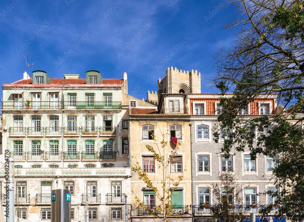 The colorful facade of old traditional residential buildings in the city downtown decored with ceramic tiles called Azulejos.Lisbon,Portugal