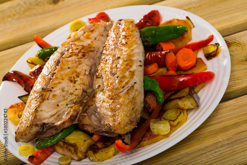 Grilled assorted vegetables served with baked mackerel - traditional Bulgarian Plakiya.. photo