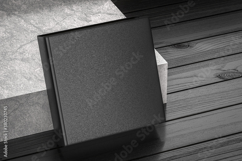 Black square blank Books Mockup with textured hard cover on wood floor near concrete stair 3d render
