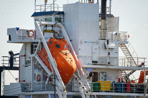 orange lifeboat on a large ship