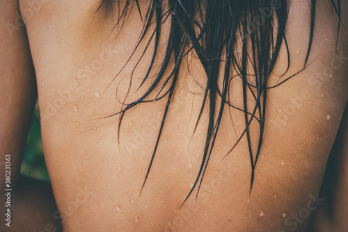 Young asian woman with wet hair on her shoulder.