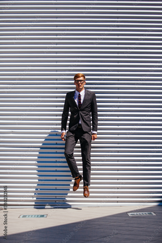 Handsome Businessman Jumping In Front a Modern Building Handsome Businessman Jumping In Front a Modern Building