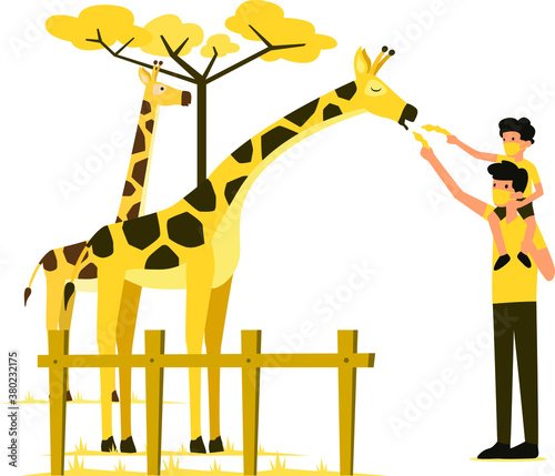 Masked man and his son feeding the giraffe in the zoo during new normal
