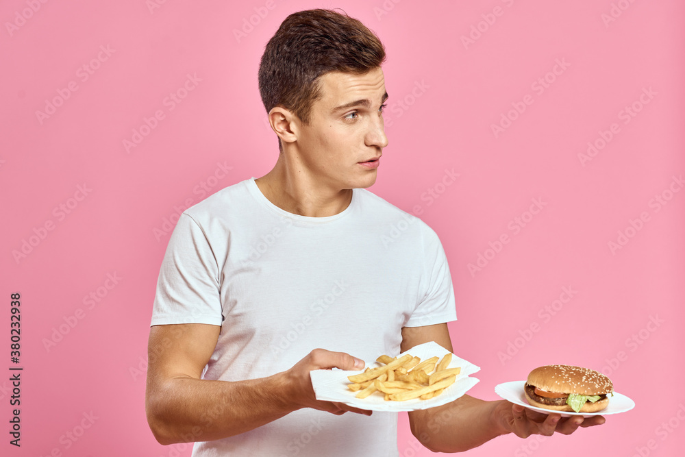 man with hamburger and fries fast food calories pink background fresh food emotion model man with hamburger and fries fast food calories pink background fresh food emotion model