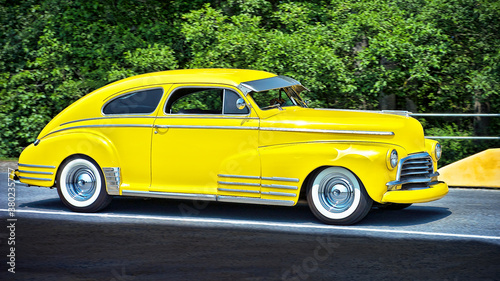Close-up of a bright yellow colored beautiful sedan sports car from the 40 s  seen around Vancouver  Canada  Northern America. No people present.