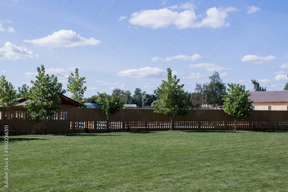 green meadow with a wooden fence