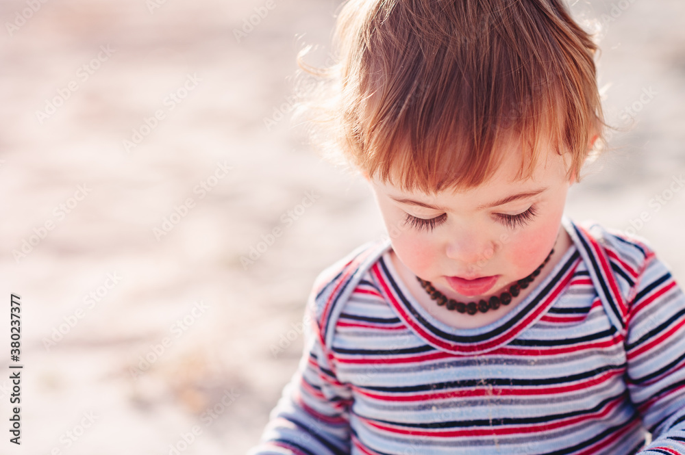 Close up of a toddler exploring the beach Close up of a toddler exploring the beach