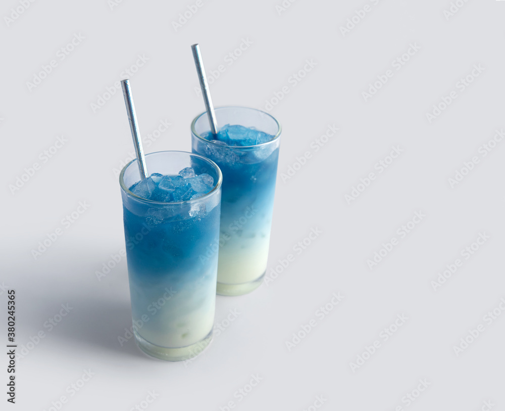 Summer refreshing beverage blue butterfly pea latte in glass on white background Summer refreshing beverage blue butterfly pea latte in glass on white background