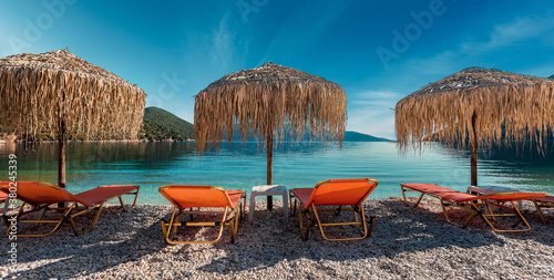 Beautiful sunny beach on Ionian sea. Summer holiday and vacation concept background. Tourism and travel wallpaper. Tranquil beach scenery. Kefalonia island, Greece, Europe. Stunning summer Landscape.