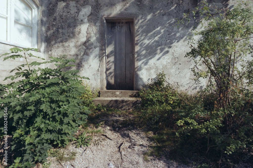 Ancient wooden door in stone wall Ancient wooden door in stone wall