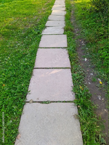 path in the park is made of concrete square slabs