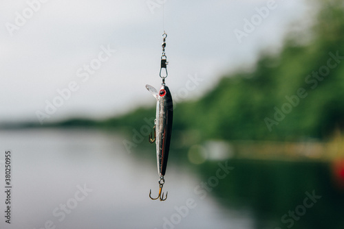 Fishing lure against lake water photo