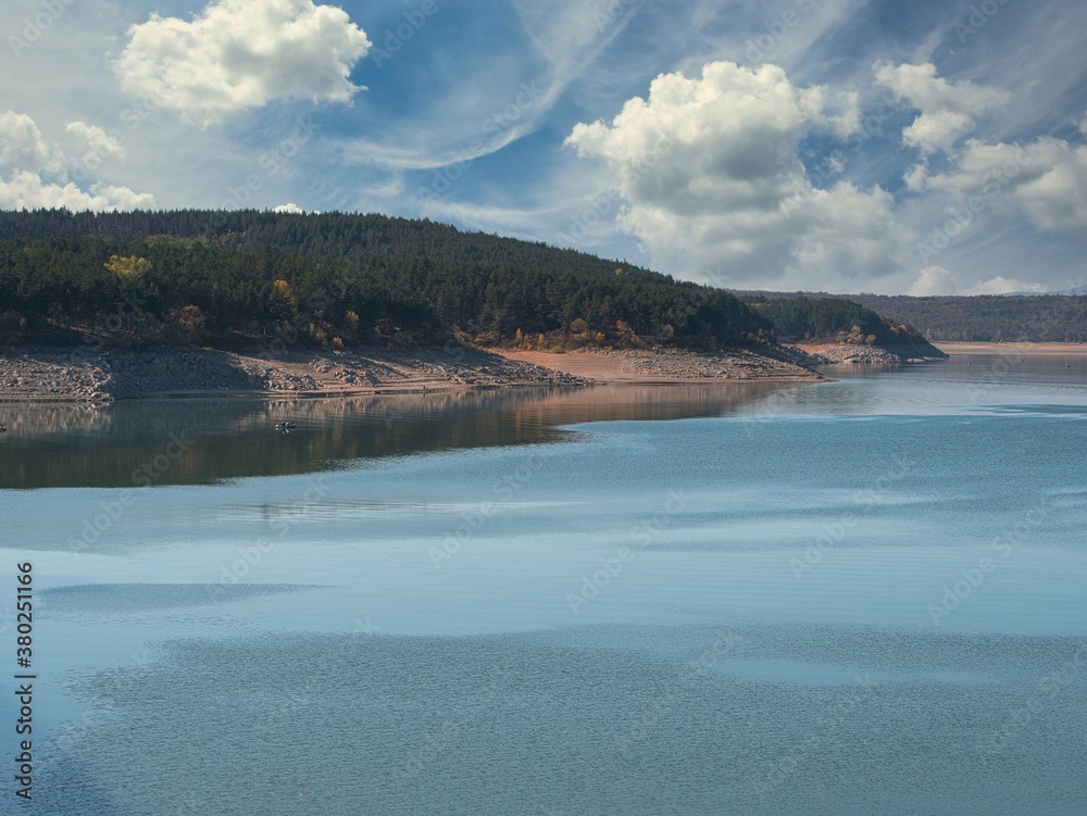 Fototapeta premium Koprinka Dam, Bulgaria in autumn. Its water has decreased. You can see its bottom.