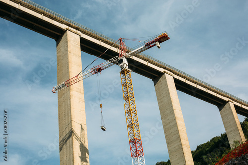 Tower crane at construction site, building a bridge