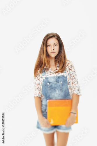 Portrait of a young teenager girl with notebook photo