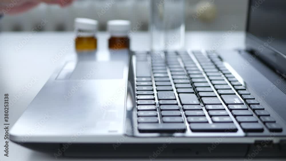 A Person at Home Due to the Coronavirus Pandemic Works Remotely and Takes Medication