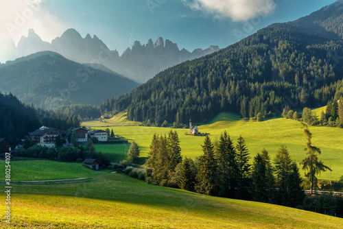 misty countryside scenery in mountains at sunrise. beautiful landscape of Dolomites with meadows rolling through forested hills in morning light. wonderful nature scene for summer background.