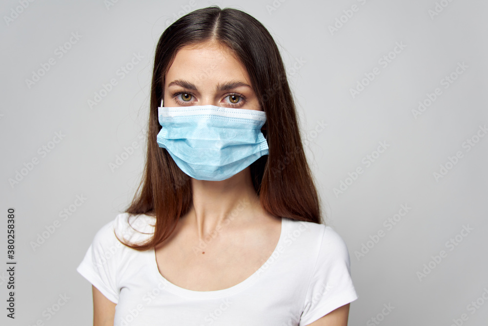Woman in medical mask Look forward white t-shirt cropped view Woman in medical mask Look forward white t-shirt cropped view