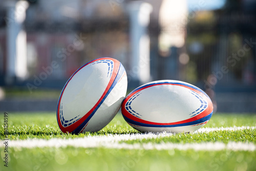 Rugby ball on the grass next to the white line