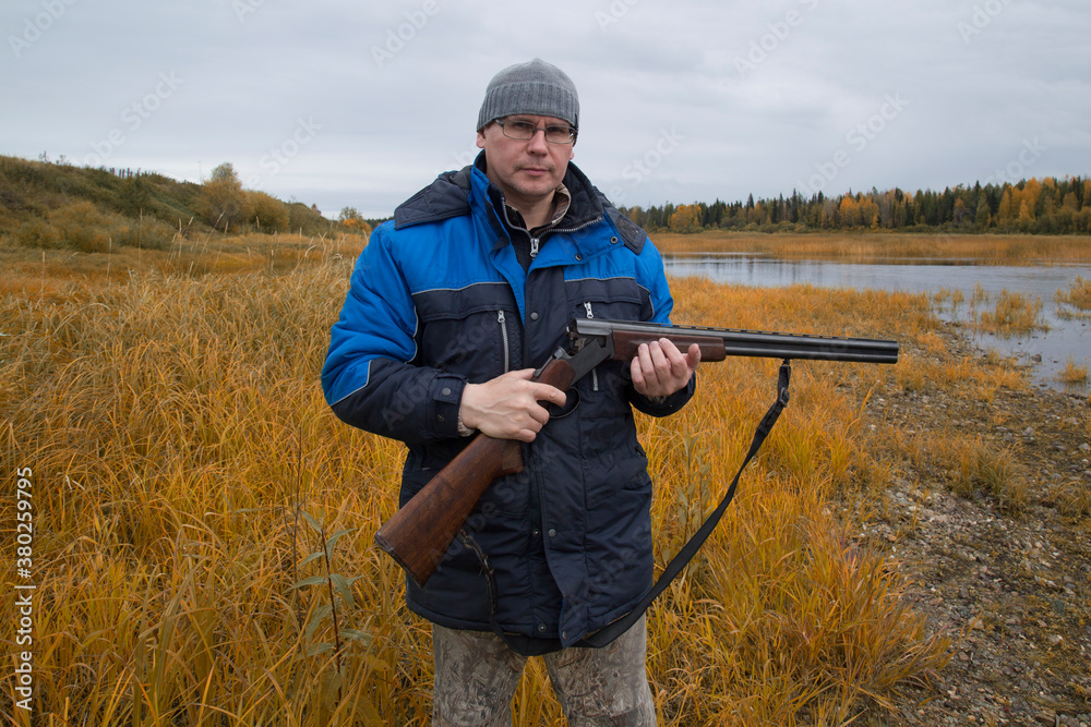Fototapeta premium Hunter with a gun . Autumn duck hunting.