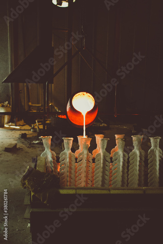 crucible pouring bronze into molds