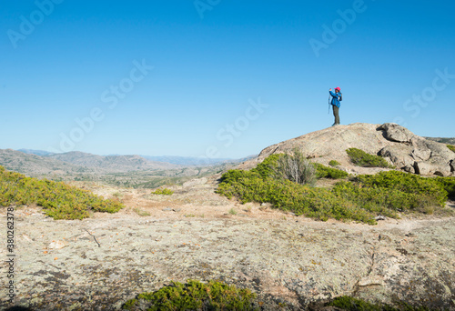 Man taking photo on rock of highland in Shinjang China photo