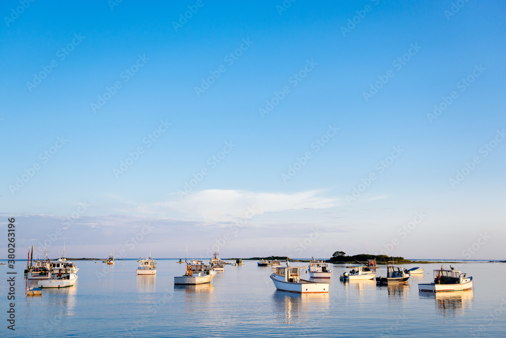 Fishing and lobster boats in a quiet Maine harbor on a summer evening Fishing and lobster boats in a quiet Maine harbor on a summer evening
