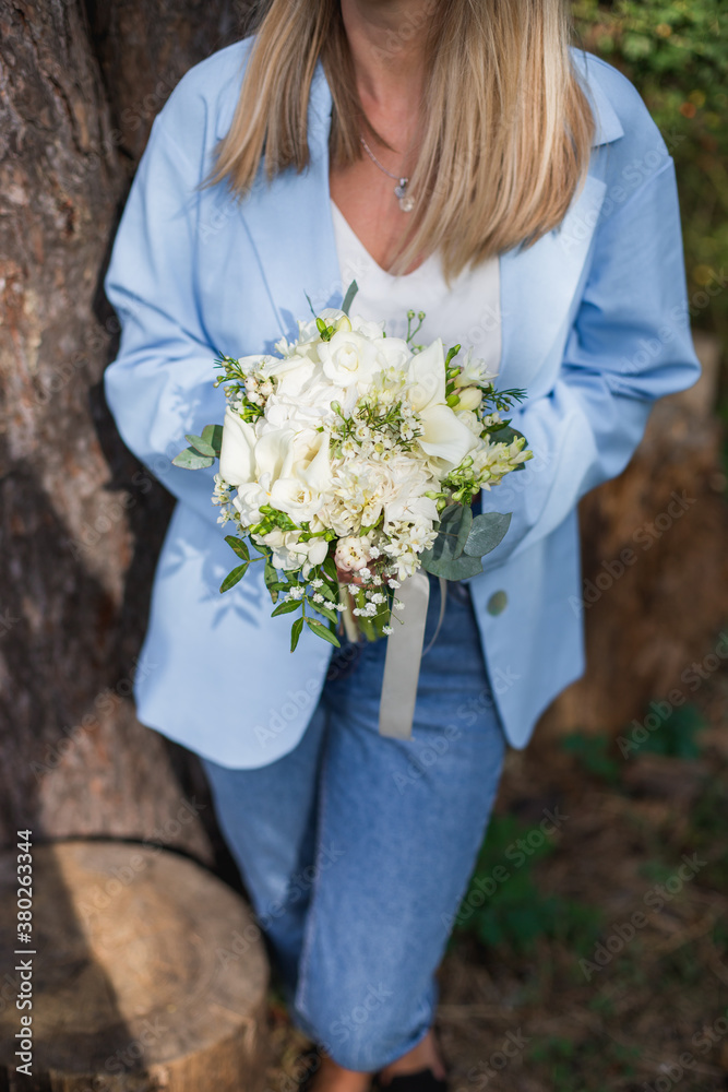 Wedding bouquet in bride hands. Roses, eustoma, eucalyptus in elegant bouquet. Summer and autumn flowers. Wedding bouquet in bride hands. Roses, eustoma, eucalyptus in elegant bouquet. Summer and autumn flowers.