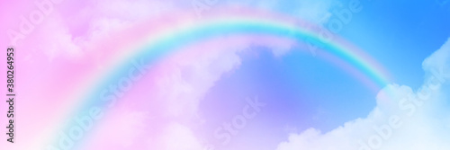  The Rainbow sky is Colorful sky with Soft clouds and a rainbow crossing. Fantasy magical sunny sky pastel background is fluffy white cloud. Freedom wallpaper concept. Sweet color dream.