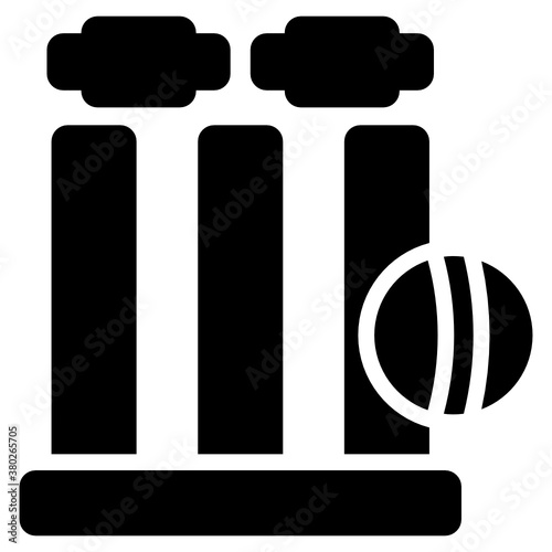 
Three wooden sticks placed together with the lid on top representing cricket wicket 
