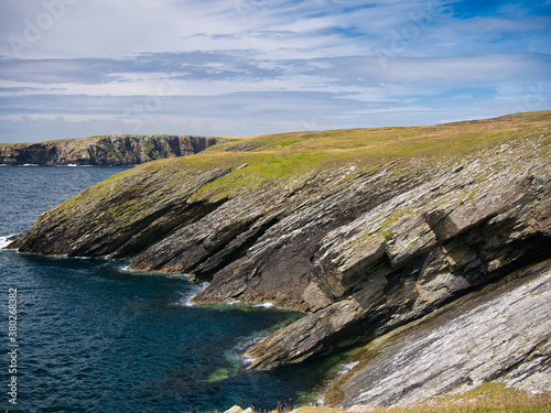 Steeply inclined eroded rock strata on Funzie Ness on the island of Fetlar in Shetland, Scotland, UK - Rocks in this area are of the Muness Phyllites Formation - Metaconglomerate - metamorphic bedrock photo