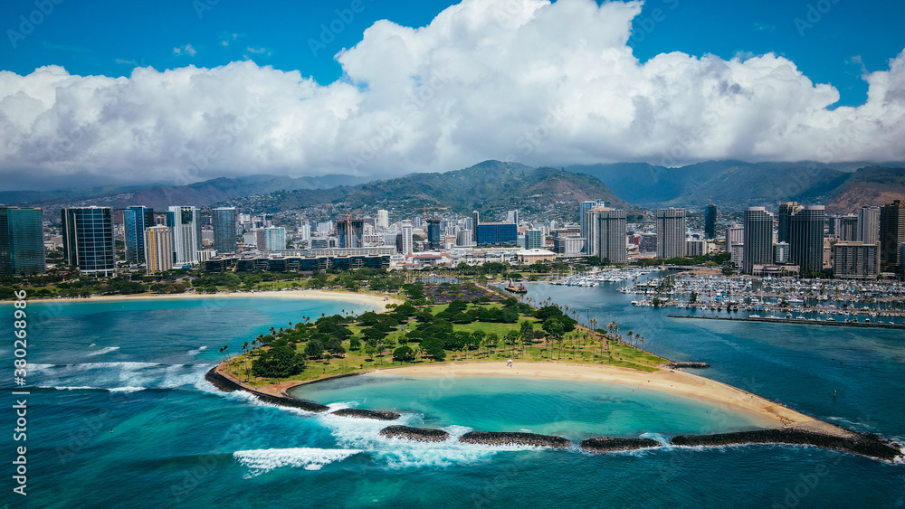 Aerial Magic Island Lagoon. Magic Island is a small man-made peninsula in Honolulu, Oahu Hawaii, adjacent to Ala Moana Beach Park and the Ala Wai Yacht Harbor.