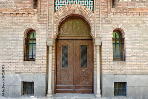 Classical doors on brick wall downtown of Madrid, Spain. Elegant entrance to the house from outside