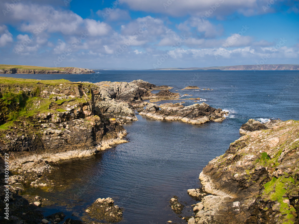 Obraz premium Dramatic coastal scenery showing inclined and eroded rock strata around the Ness of Queyon, near Otters Wick on the island of Yell in Shetland, Scotland, UK - metamorphic bedrock
