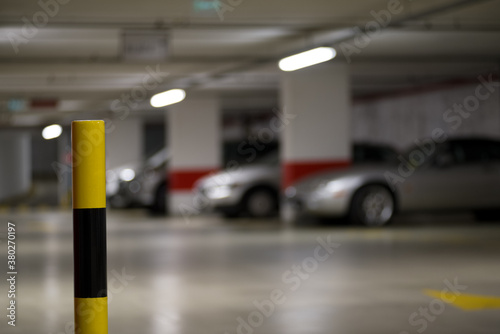 Yellow-black striped post in a parking garage
